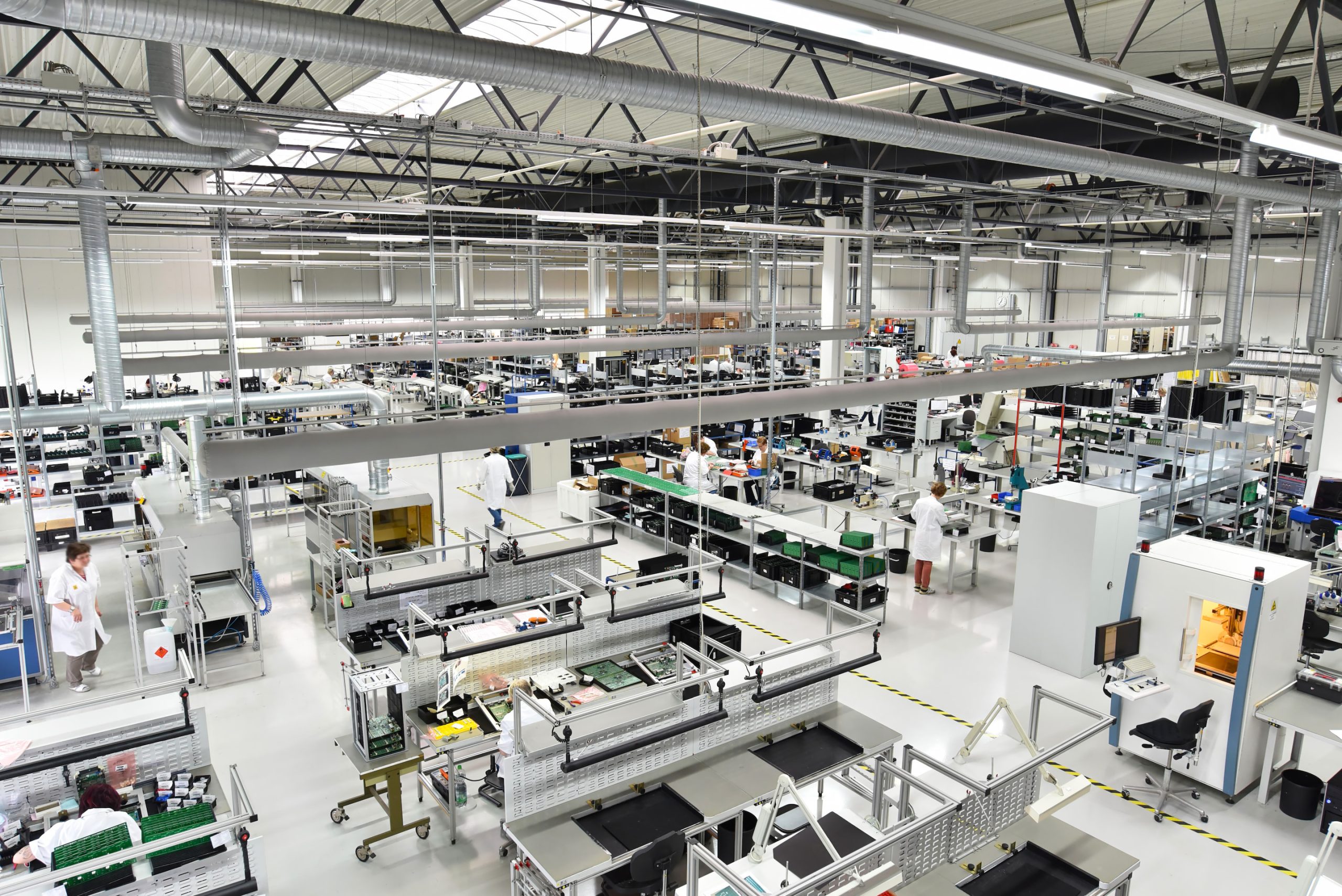 Wide angle image of large IoT manufacturing factory with lots of machines.